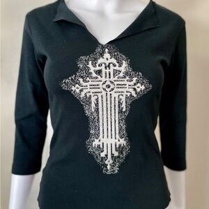 Black three-quarter sleeve top, white and silver beaded textured cross on front.
